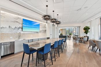 A large kitchen and dining room with a long table and chairs